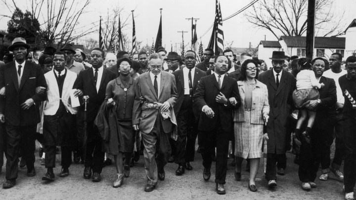 30th March 1965: American civil rights campaigner Martin Luther King (1929 - 1968) and his wife Coretta Scott King lead a black voting rights march from Selma, Alabama, to the state capital in Montgomery. (Photo by William Lovelace/Express/Getty Images)
